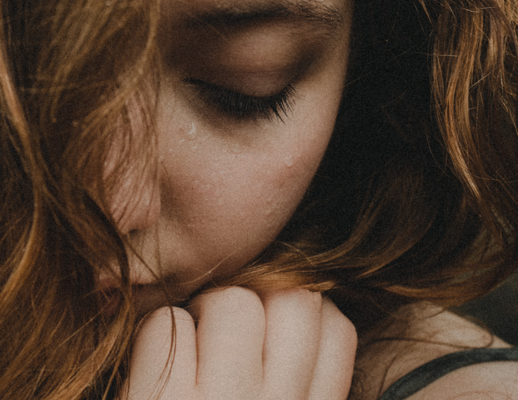 ARTEBELLA Skin Health on Bowen Island showing a closeup of a girl's hydrated skin experiencing the rain and soft introspection. 
